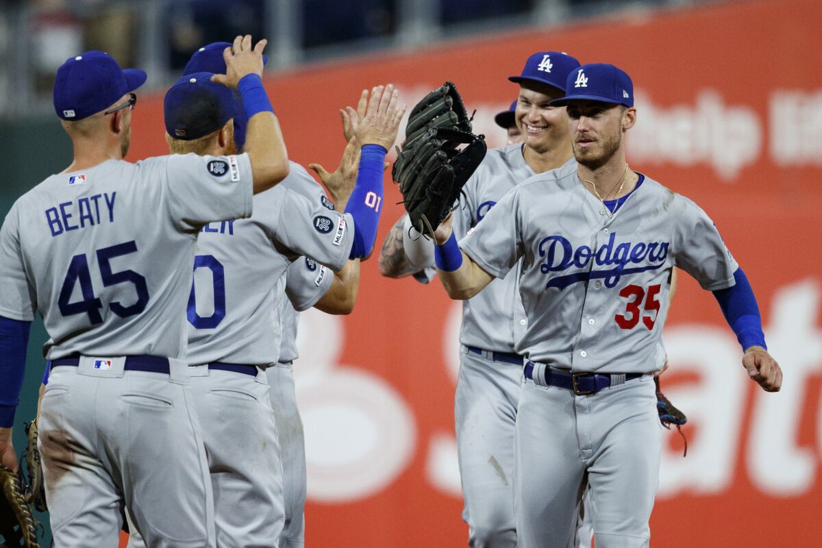 Dodgers' Cody Bellinger, right, celebrates with teammates after beating the Philadelphia Phillies on July 15 in Philadelphia.