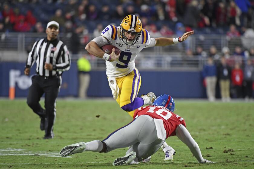 LSU quarterback Joe Burrow (9) avoids Mississippi linebacker Jacquez Jones (10) during the first half of an NCAA college football game in Oxford, Miss., Saturday, Nov. 16, 2019. (AP Photo/Thomas Graning)