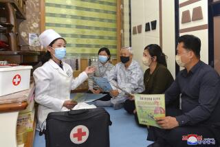In this photo provided by the North Korean government, a doctor visits a family during an activity to raise public awareness of the COVID-19 prevention measures, in Pyongyang, North Korea Tuesday, May 17, 2022. Independent journalists were not given access to cover the event depicted in this image distributed by the North Korean government. The content of this image is as provided and cannot be independently verified. Korean language watermark on image as provided by source reads: "KCNA" which is the abbreviation for Korean Central News Agency. (Korean Central News Agency/Korea News Service via AP)
