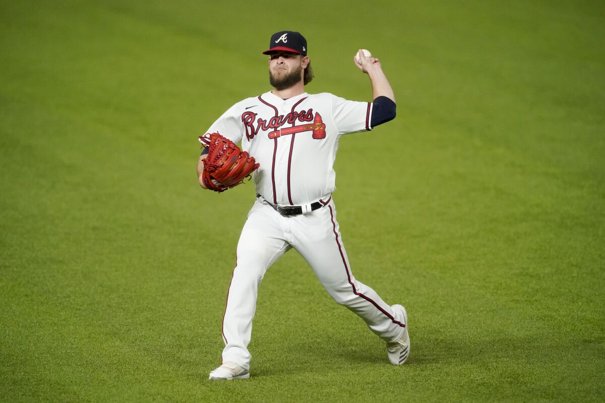 Atlanta Braves pitcher A.J. Minter warms up before Game 5 of the NLCS on Friday.