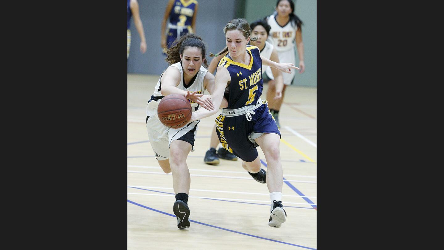 Holy Family's Michelle Barraza and St. Monica Academy's Katherine Golbranson charge forward for a loose ball in a nonleague girls' basketball game at Pacific Park Community Center on Thursday, November 30, 2017.