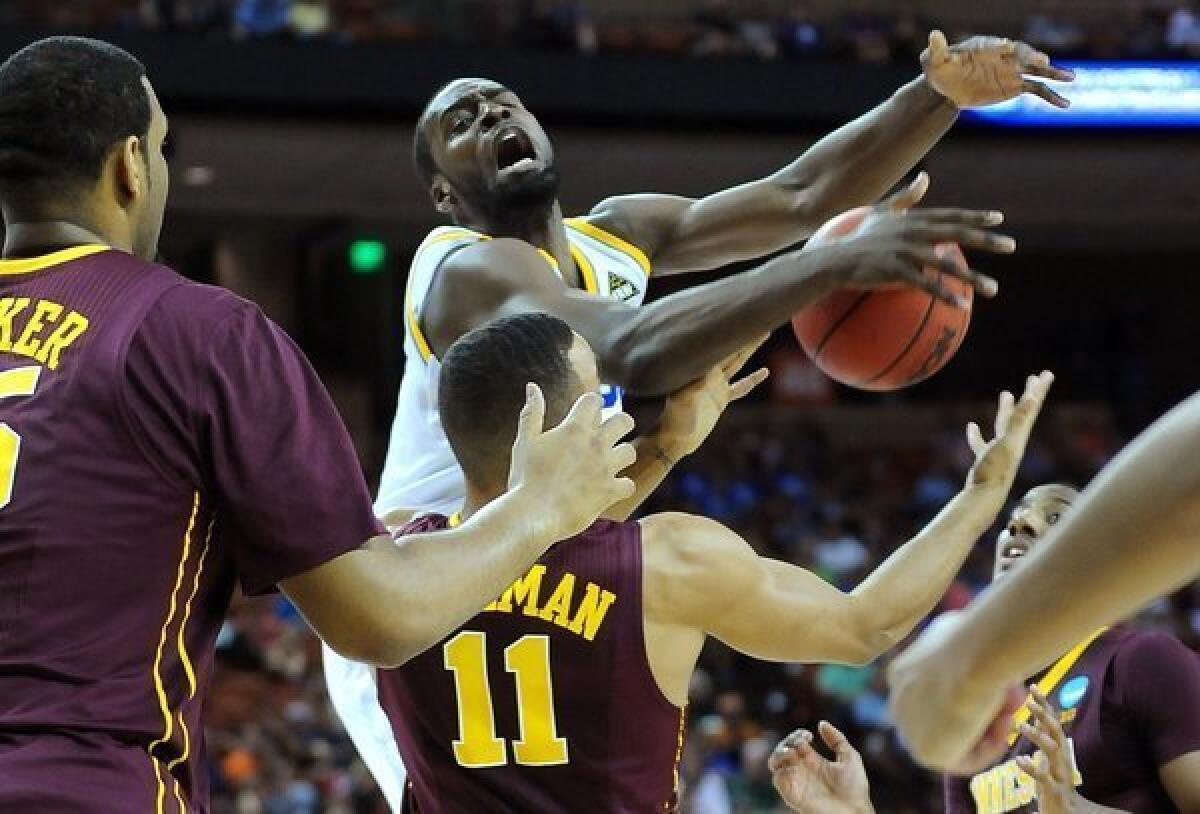 UCLA guard Shabazz Muhammad is fouled by Minnesota guard Joe Coleman on a drive to the basket in the first half Friday night.
