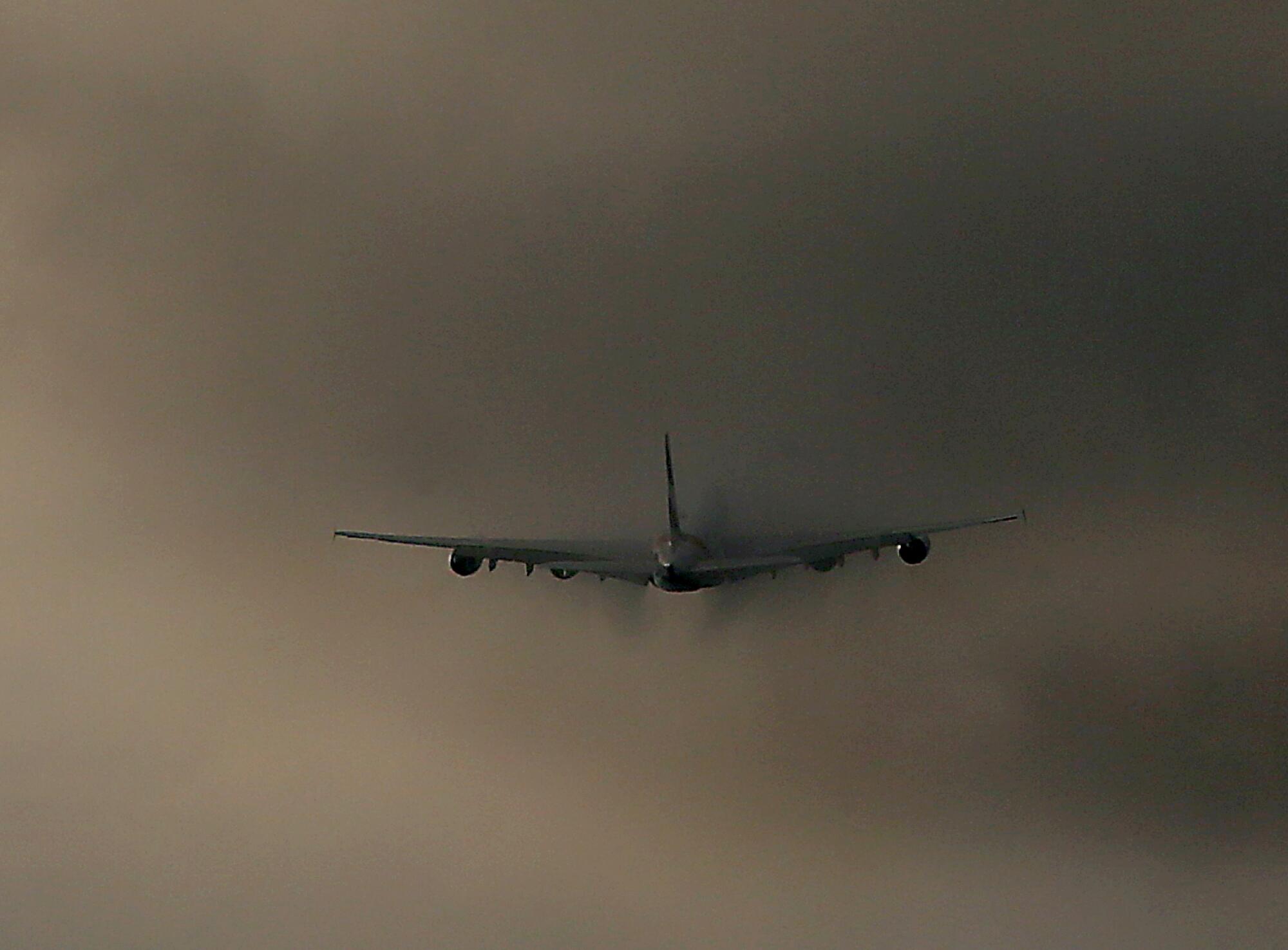 A jet flies into clouds.