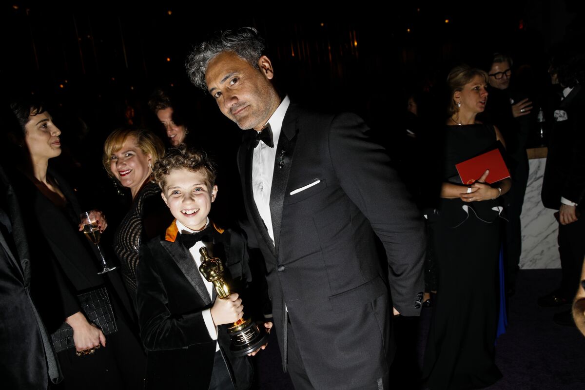 Roman Griffin Davis and director Taika Waititi at the Academy Awards Governors Ball on Feb. 9, 2020 