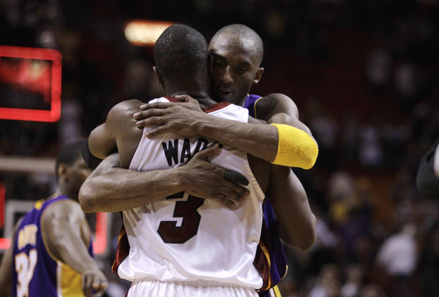 Miami Heat guard Dwyane Wade (3) is hugged by Los Angeles Lakers guard Kobe Bryant following an NBA basketball game in Miami, Thursday, March 4, 2010. (AP Photo/Lynne Sladky)