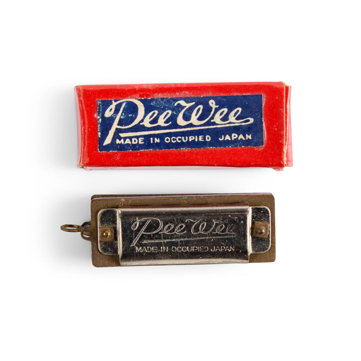 A vintage "Pee Wee" brand harmonica with box.