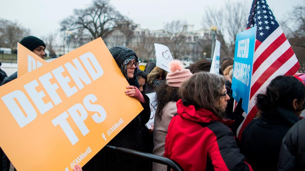 Immigrants and activists protest near the White House on Jan. 8 to demand that the Department of Homeland Security extend Temporary Protected Status for more than 260,000 Salvadorans in the United States.