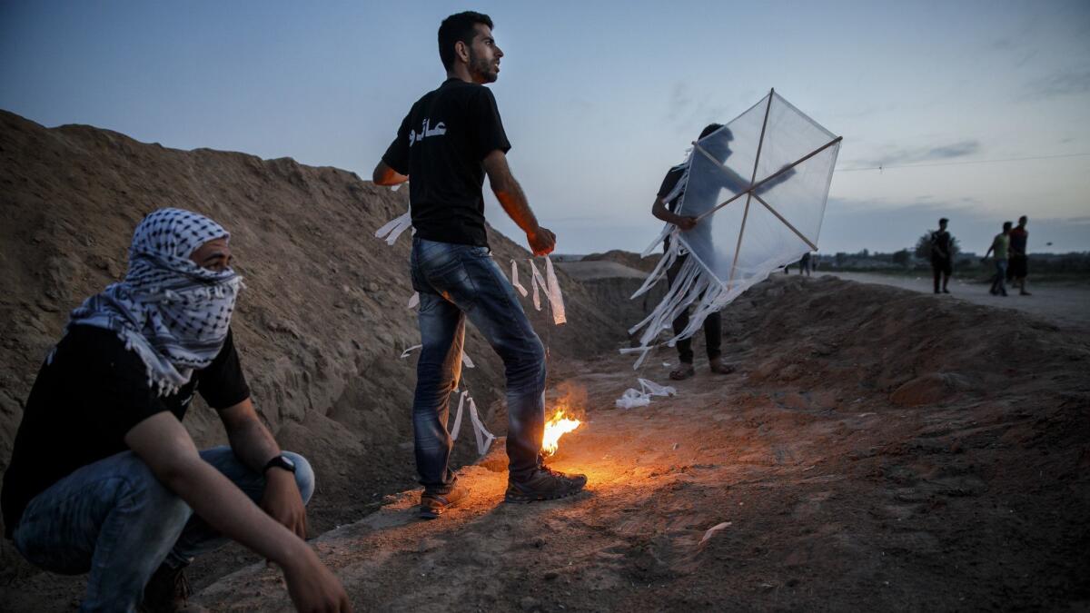 Palestinians test out kites that carry torches, to use for the Great March of Return, at the Bureij refugee camp near Deir al-Bala, Gaza Strip, on May 9.