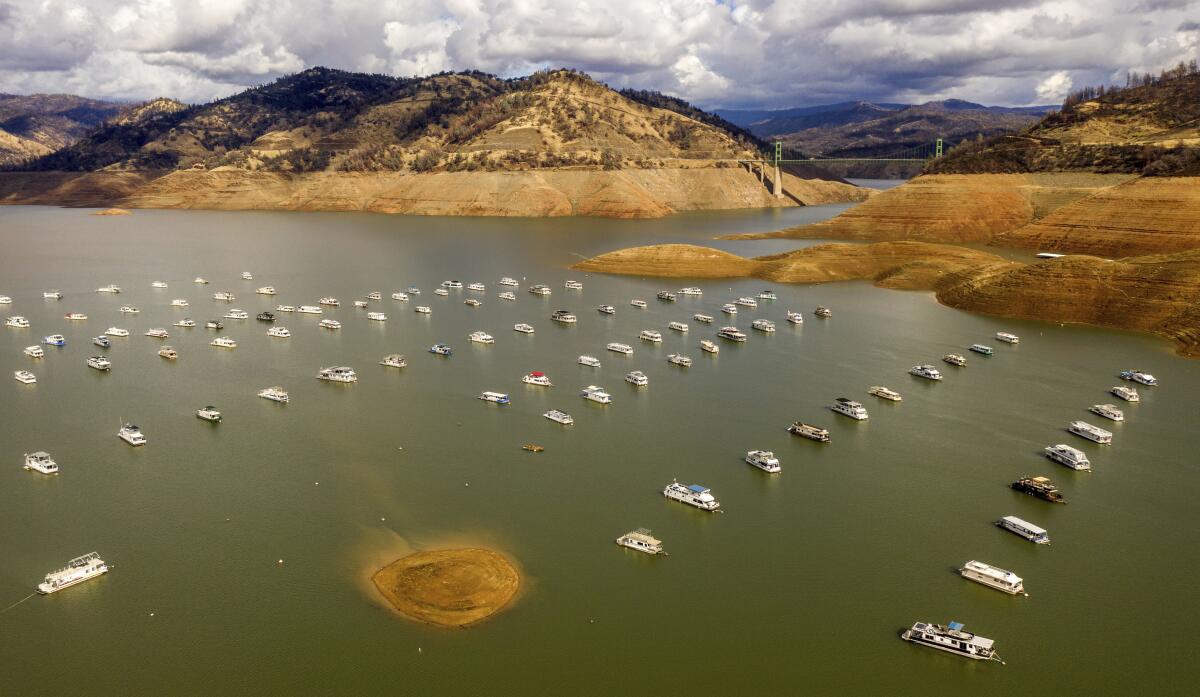 Rows of houseboats on a lake with water levels far below normal