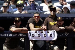 San Diego Padres Manny Machado, second from left, looks on against the New York Yankees during the first inning of a baseball game Sunday, May 28, 2023, in New York. (AP Photo/Adam Hunger)