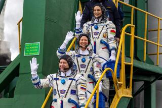 In this photo released by Roscosmos space corporation, NASA astronaut Tracy Dyson, centre, Oleg Novitsky of Roscosmos, bottom, and Marina Vasilevskaya of Belarus wave as they board to the space ship at the Russian leased Baikonur cosmodrome, Kazakhstan, Thursday, March 21, 2024. Russia's Roscosmos space agency has aborted the launch of three astronauts to the International Space Station about 20 seconds before they were scheduled to lift off. Officials say the crew is safe. The Russian Soyuz rocket was to carry NASA astronaut Tracy Dyson, Oleg Novitsky of Roscosmos and Marina Vasilevskaya of Belarus from the Russia-leased Baikonur launch facility in Kazakhstan. (Roscosmos space corporation via AP)