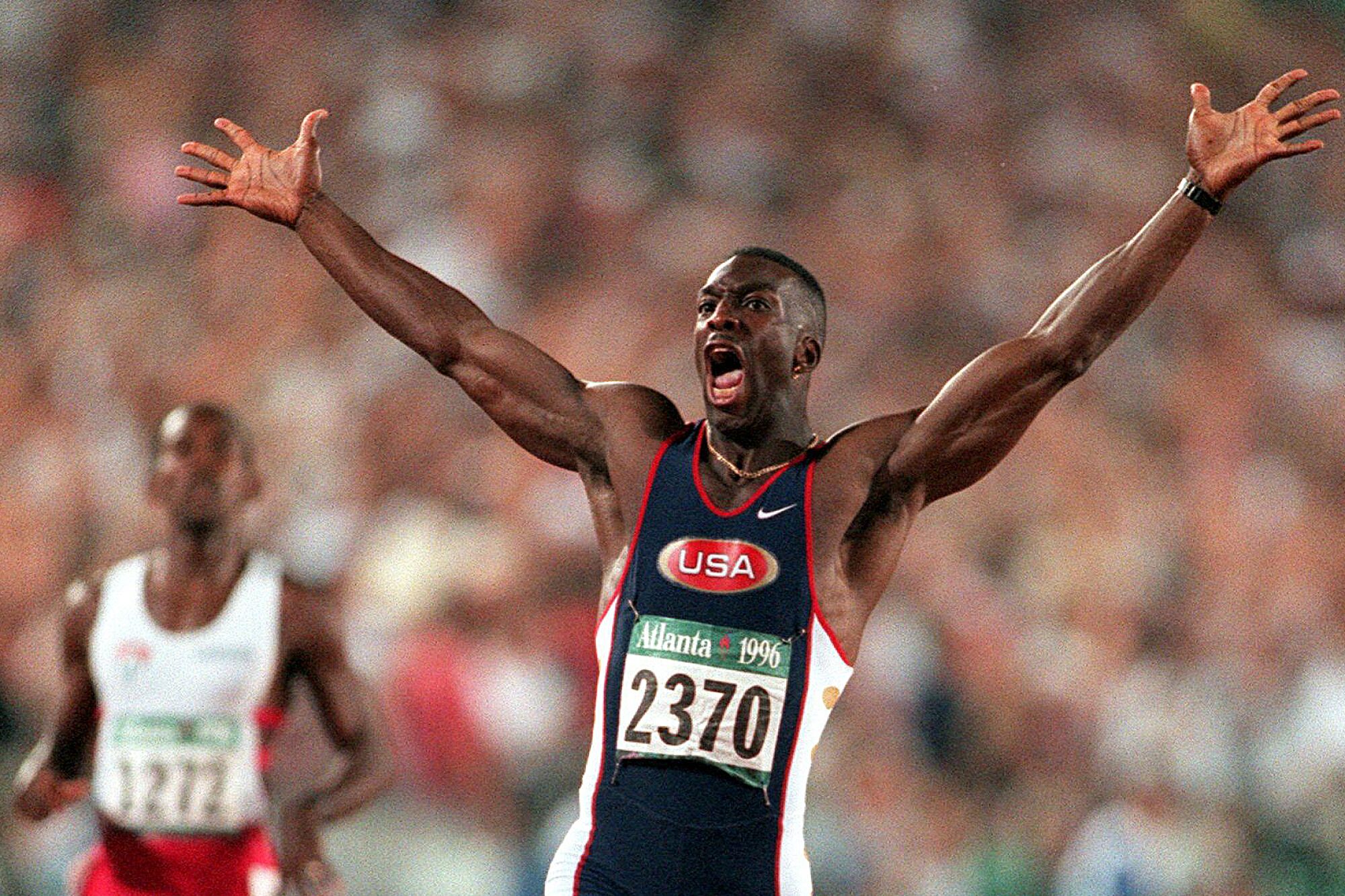 Michael Johnson celebrates after he won the men's 200 meter final in 1996.