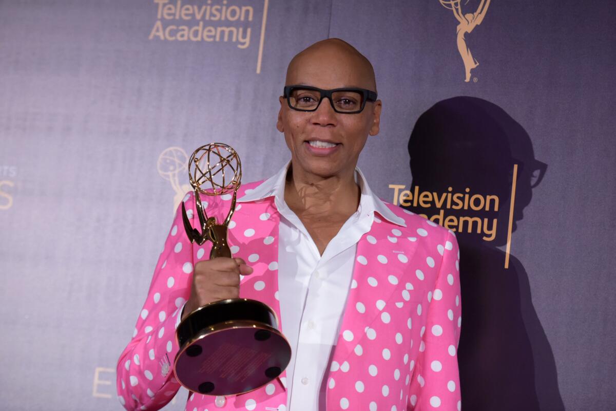 RuPaul Charles poses in the press room with his award for outstanding host for a reality or reality-competition program for “RuPaul’s Drag Race” on Sunday.