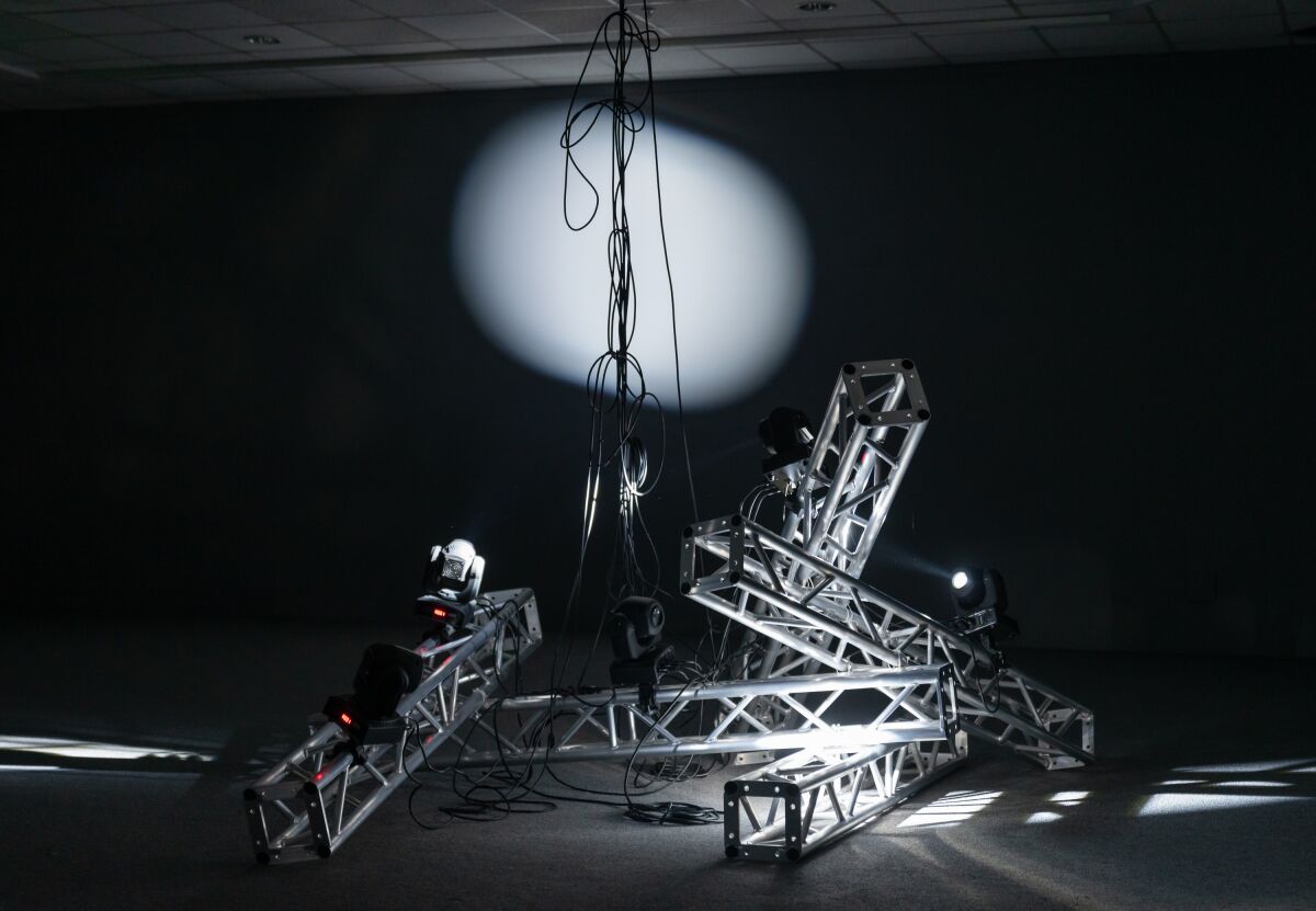 An art installation of fallen lights and scaffolding