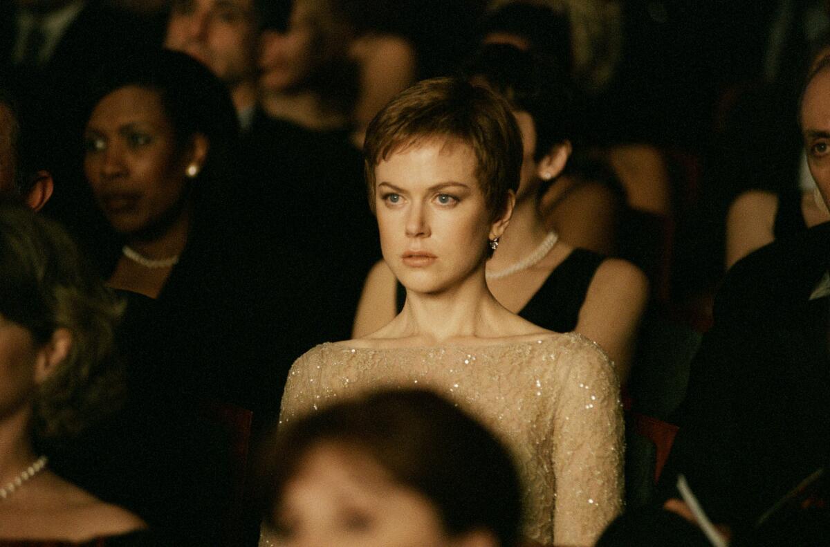 Nicole Kidman, in "Birth," sits in an audience looking intensely forward.