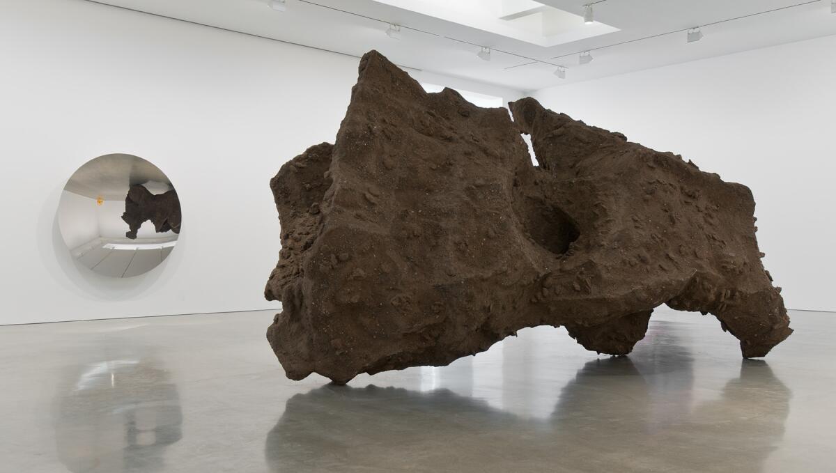 Sculptor Anish Kapoor takes over Regen Projects with new works that include the show-stopper, "Gabriel, the Angel, stops and listens to the silence of the cave," made of resin and earth.