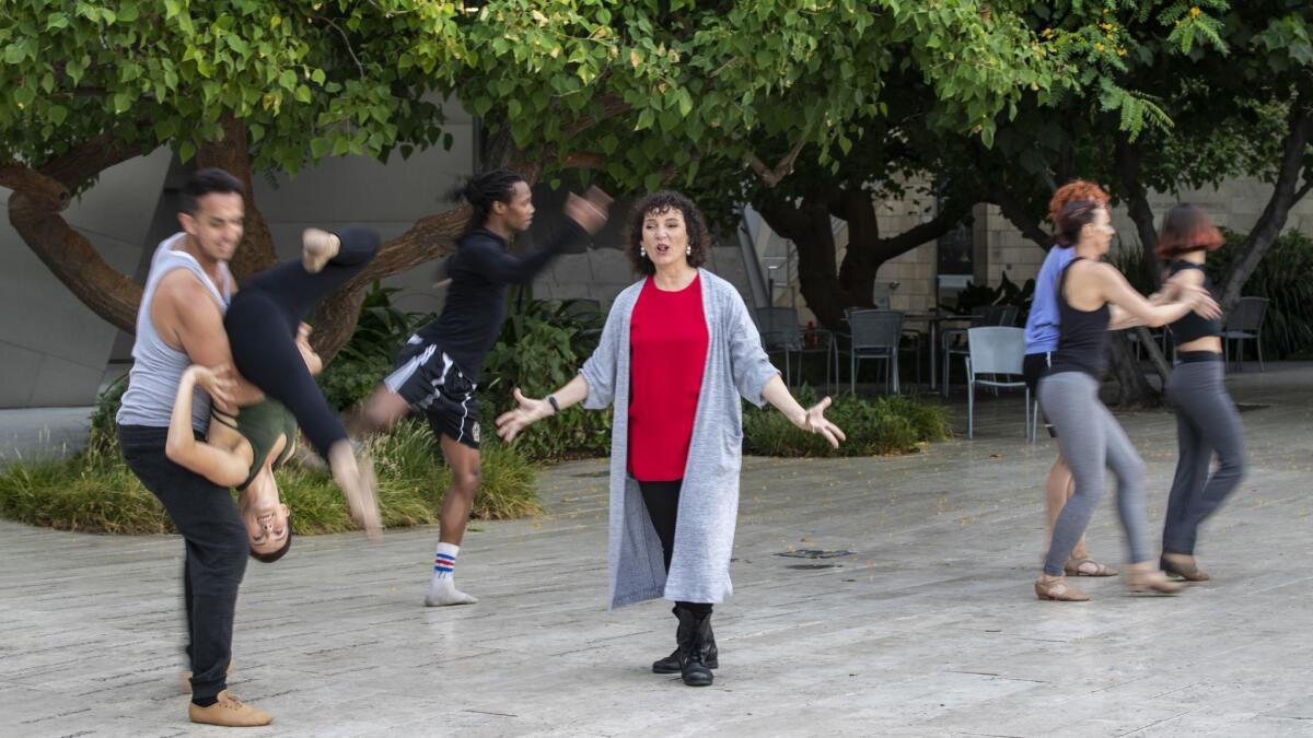 Choreographer Janet Roston, center, rehearses her company Mixed eMotion Theatrix last month at the Blue Ribbon Garden of the Walt Disney Concert Hall. Roston is one of three featured choreographers in the Music Center's Moves After Dark dance program.
