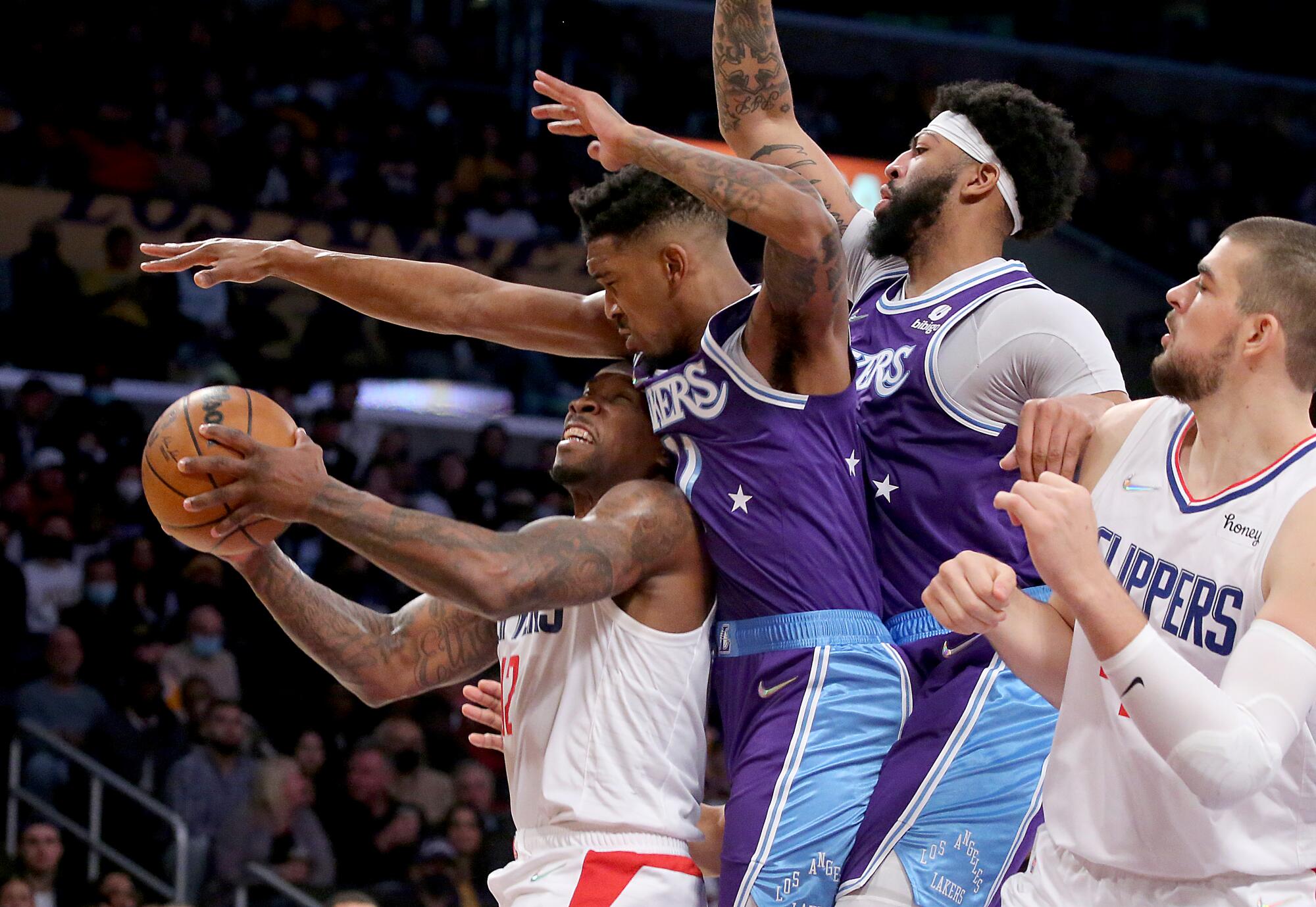 Lakers guard Eric Bledsoe is fouled by Lakers guard Malik Monk.