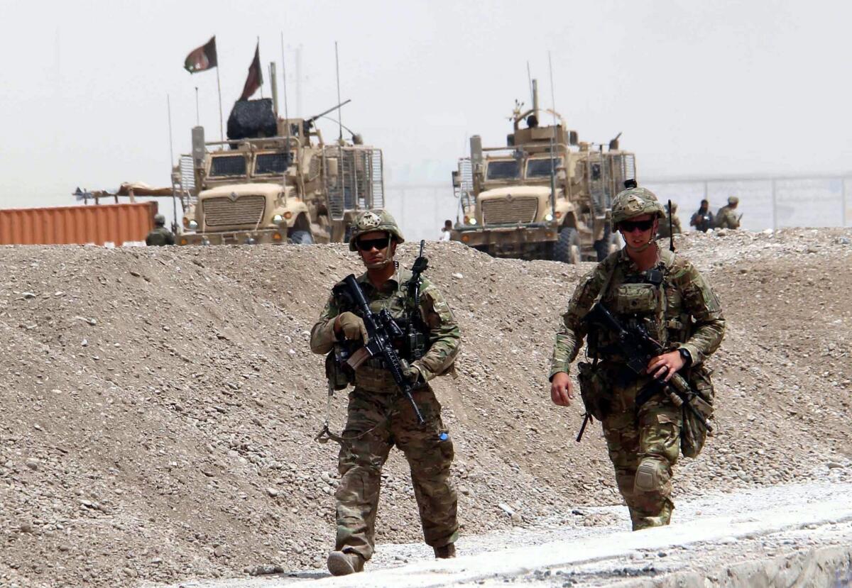 NATO soldiers secure the scene of a suicide bomb attack that targeted a NATO convoy in Kandahar, Afghanistan on Wednesday.