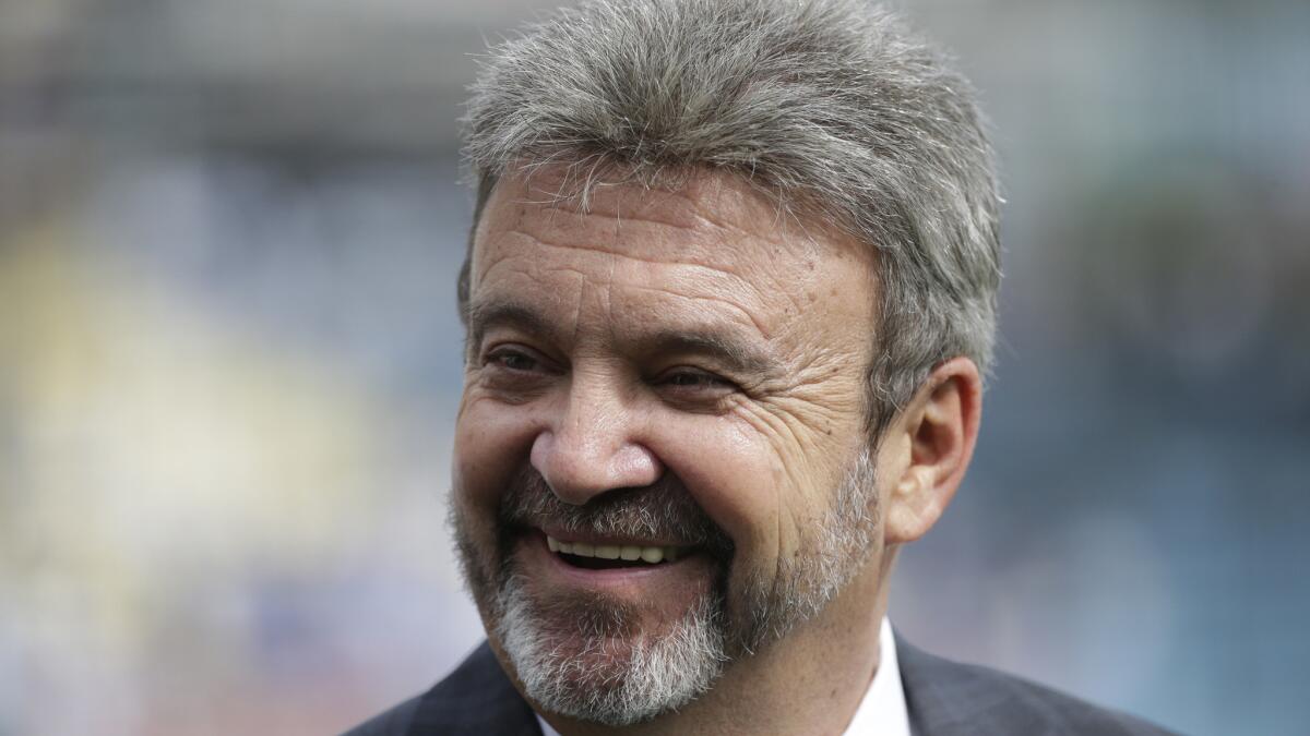 Dodgers General Manager Ned Colletti smiles before a game against the San Francisco Giants in April. Colletti says he wants to sign shortstop Hanley Ramirez to a contract extension.