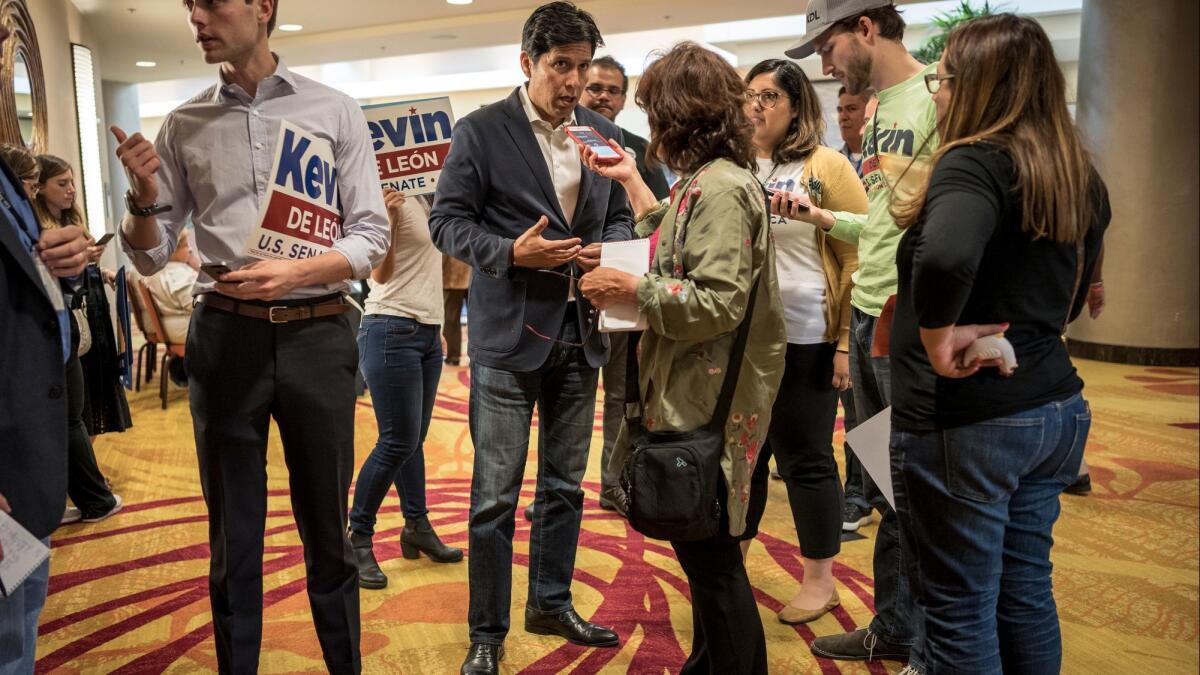 Kevin de León, center, speaks to reporters this weekend, has won support from the state party's liberal core and powerful labor organizations.