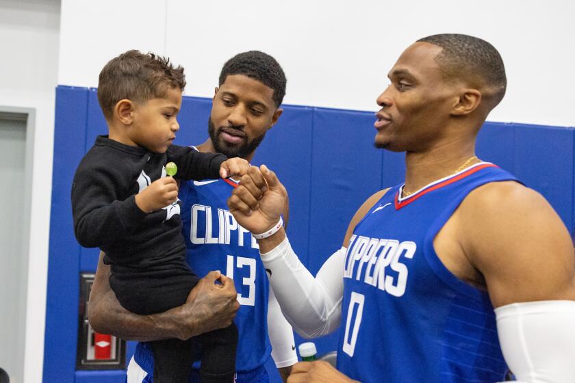 Playa Vista, CA - October 02: Russel Westbrook greets Paul George and his son Paul Vuk during LA Clippers media day on Monday, Oct. 2, 2023 in Playa Vista, CA. (Jason Armond / Los Angeles Times)