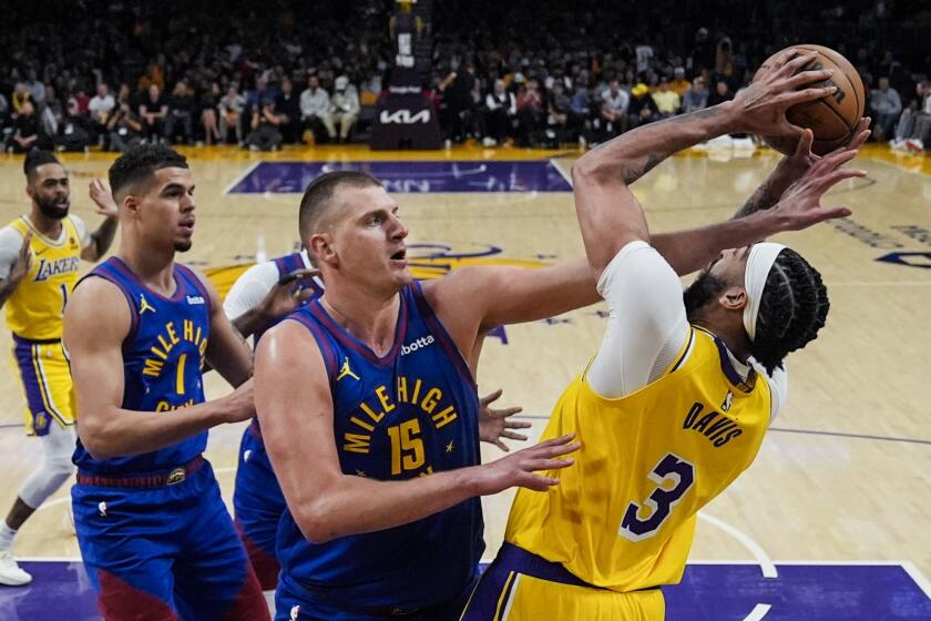 Denver Nuggets center Nikola Jokic (15) defends against Los Angeles Lakers forward Anthony Davis (3) during the first half of Game 3 of an NBA basketball first-round playoff series in Los Angeles, Thursday, April 25, 2024. (AP Photo/Ashley Landis)