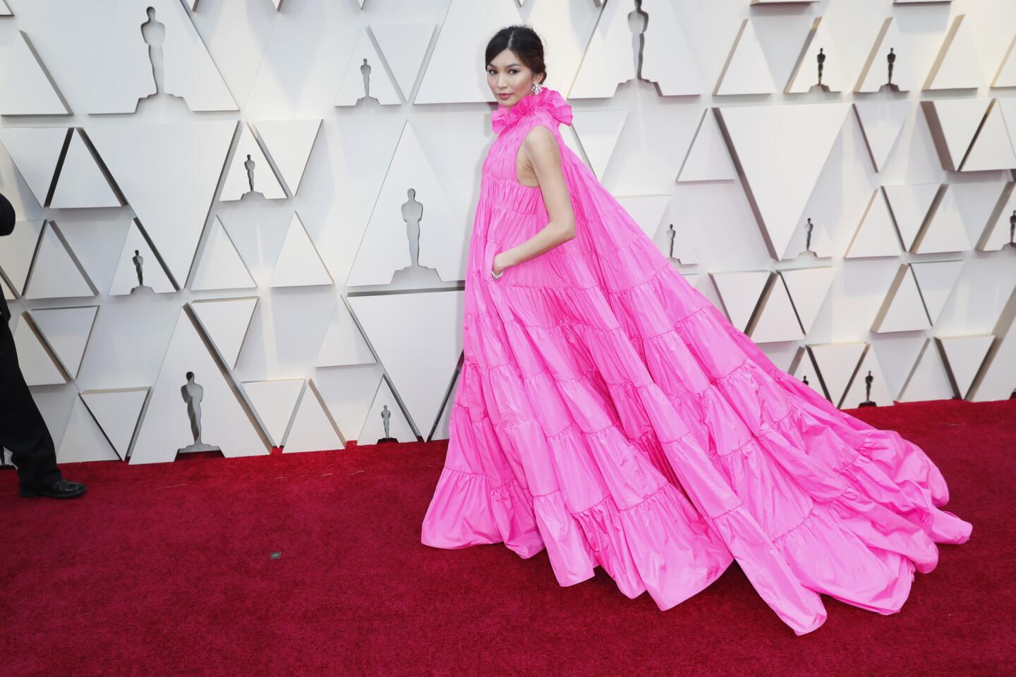 HIT: Gemma Chan sent the internet a flutter in a billowing fuchsia taffeta Valentino gown with expanding frills (and pockets!) and earrings from Bulgari.