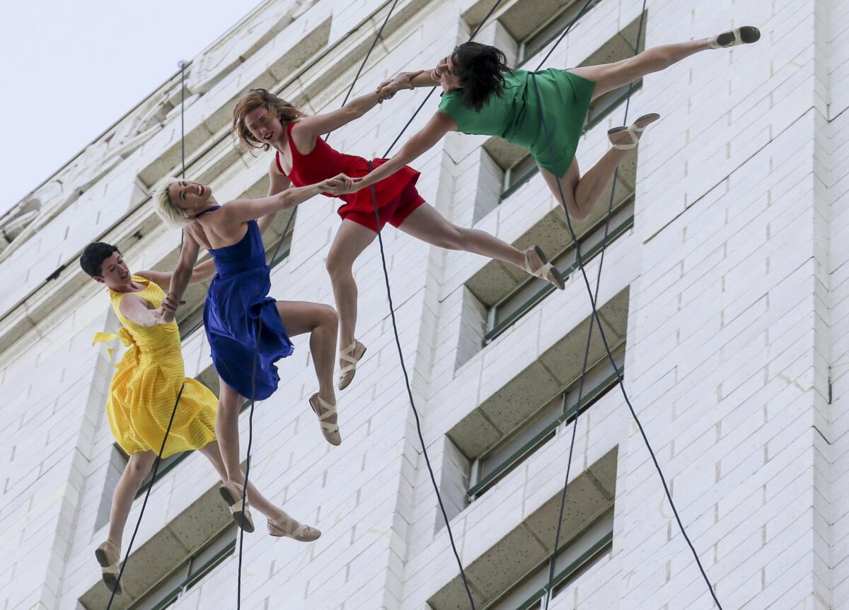 Aerial dancers rappel down City Hall and dance across the tower at the event held by Mayor Eric Garcetti declaring April 25 "La La Land" Day in honor of the award-winning film and its director Damien Chazelle.