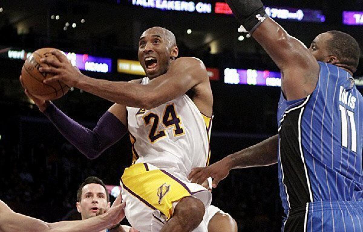 Lakers guard Kobe Bryant, driving to the basket against the Magic's Glen Davis, had the best statistical month of any during his 17 seasons in the NBA.