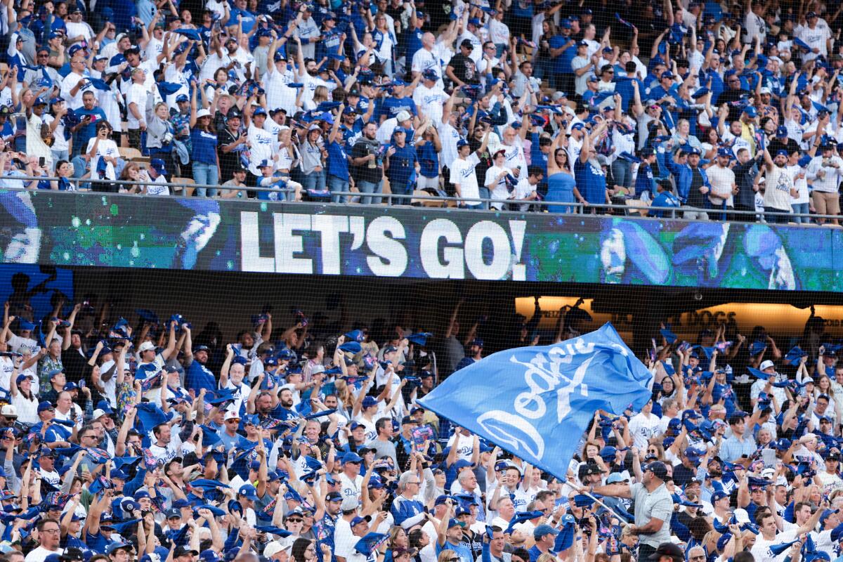 Dodgers fans cheer before the start of Game 6 of the NLCS at Dodger Stadium on Sunday.