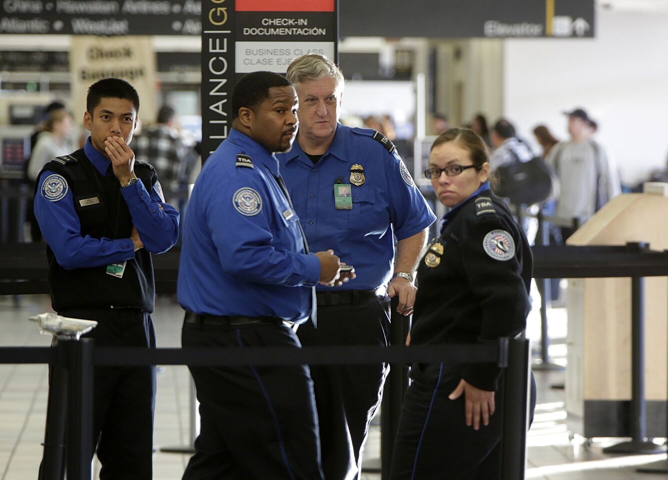 TSA officers are in very somber mood at the Terminal 3 check-in area.