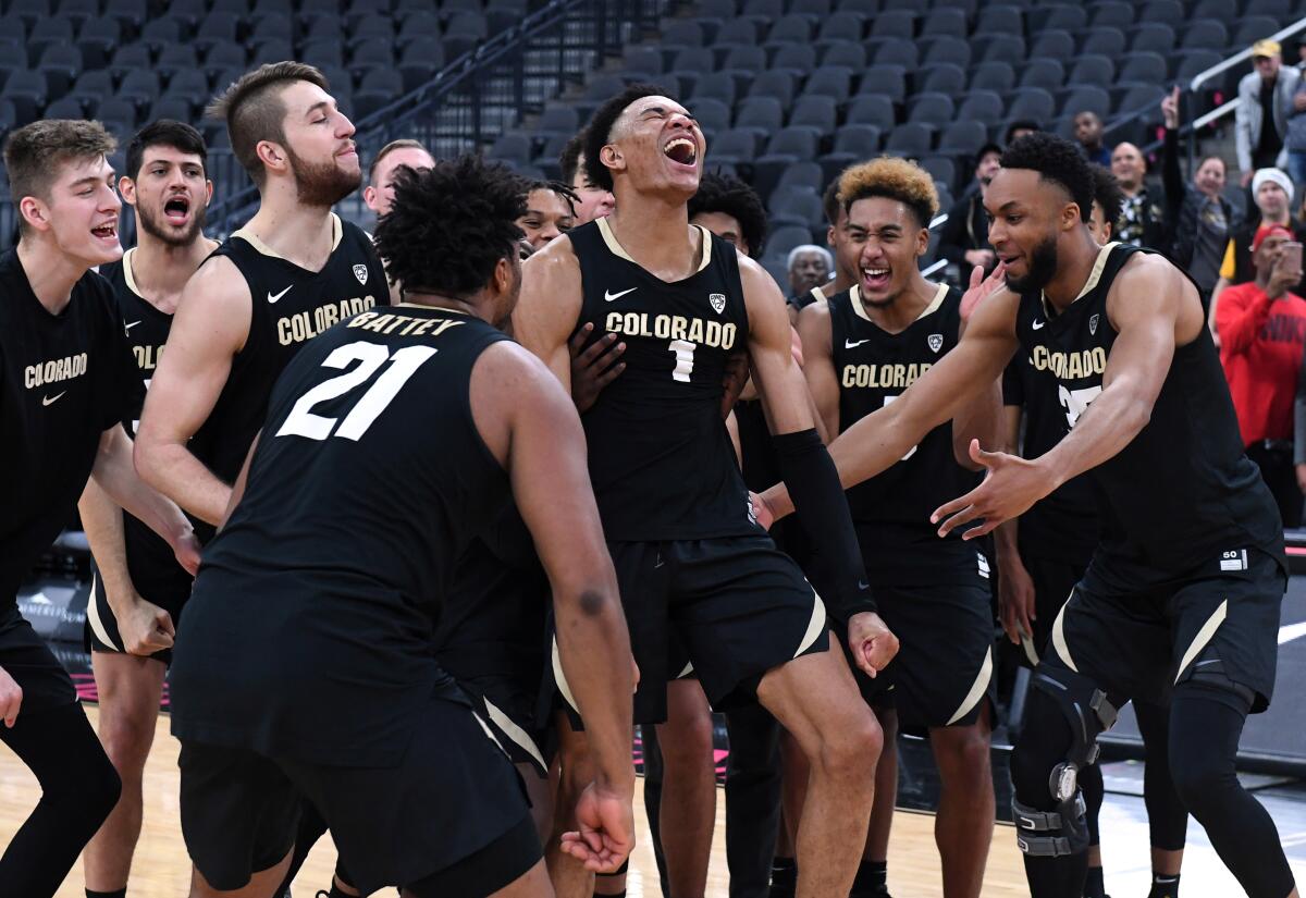 Colorado junior guard Tyler Bey (1) celebrates with teammates after being declared the MGM Resorts Main Event basketball tournament MVP on Nov. 26.