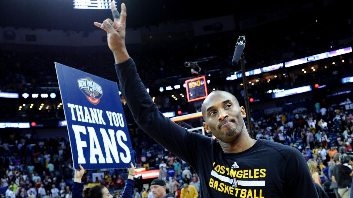 Kobe Bryant waves goodbye to fans as the Lakers leave the court following their loss to the Pelicans on Friday night in New Orleans.