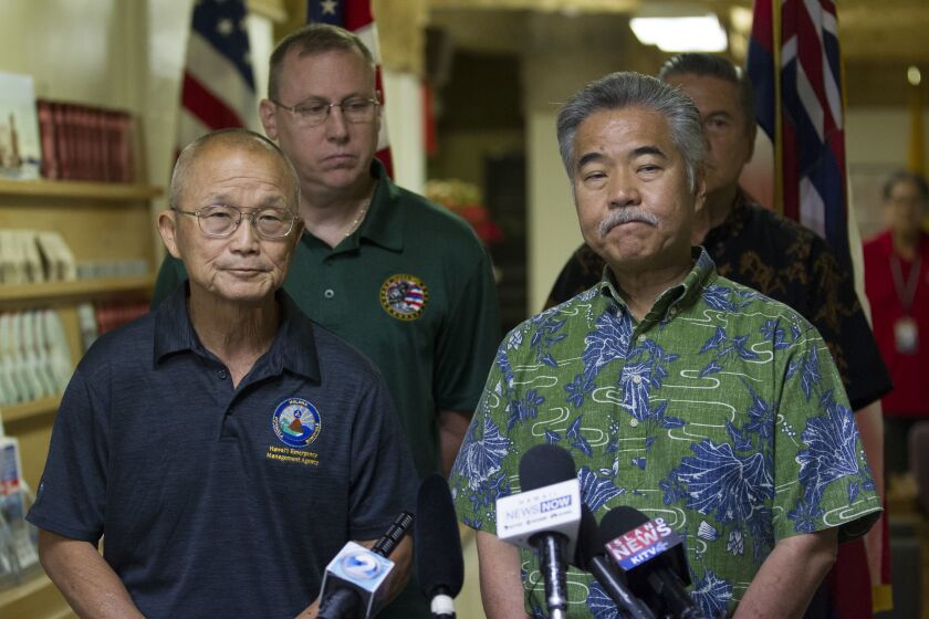 FILE - Vern Miyagi, Administrator, HEMA, left, and Hawaii Gov. David Ige addressed the media during a press conference at the Hawaii Emergency Management Center at Diamond Head following the false alarm issued of a missile launch on Hawaii on Jan. 13, 2018. As Hawaii's governor, David Ige faced a false alert about an incoming ballistic missile, a volcanic eruption that destroyed 700 homes and protesters blocking construction of a cutting-edge multibillion-dollar telescope. (George F. Lee/The Star-Advertiser via AP, File)
