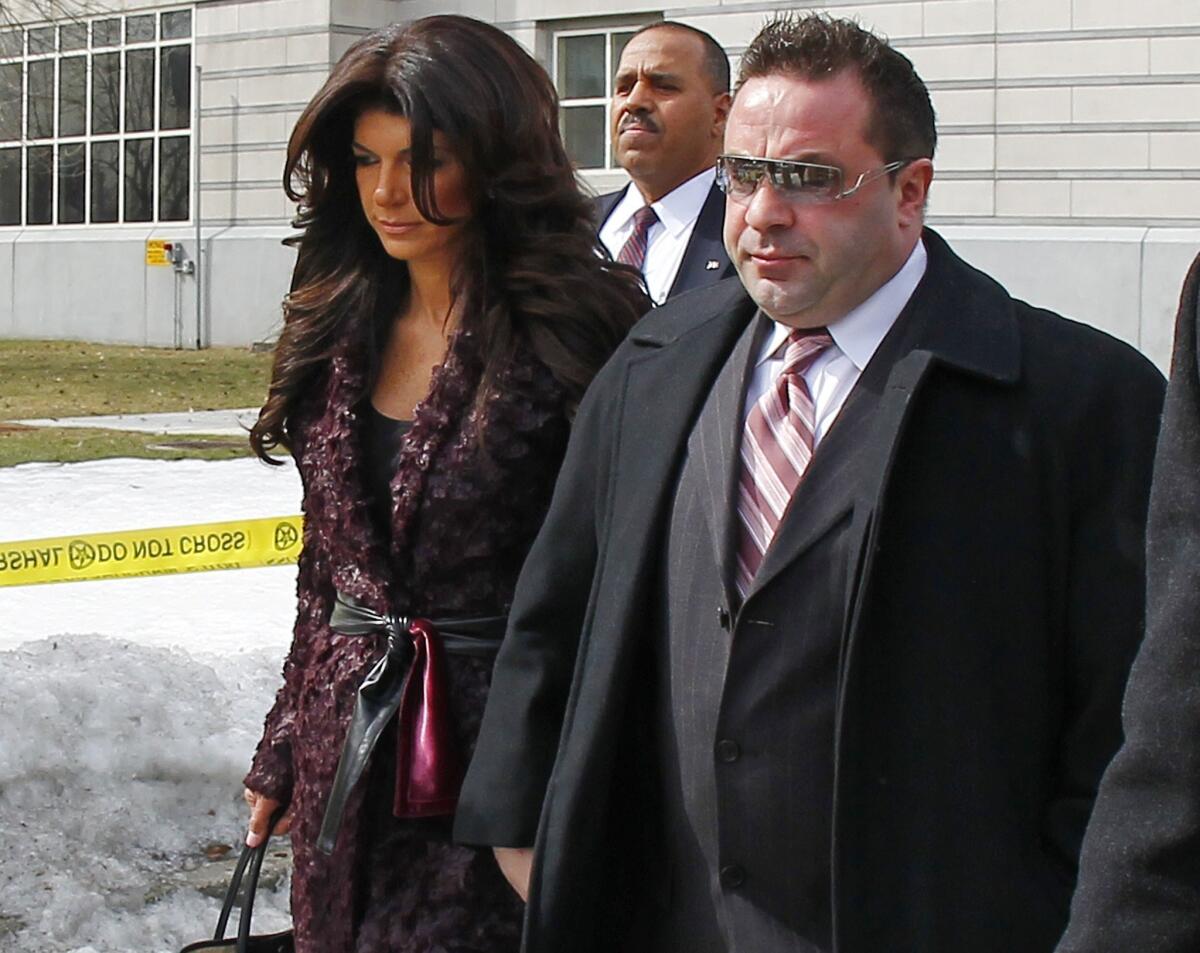 Teresa Giudice, left, and Joe Giudice, from "The Real Housewives of New Jersey," leave federal court in Newark, N.J. They each pleaded guilty to several counts, including bankruptcy fraud, conspiracy to commit mail and wire fraud and failing to pay taxes.
