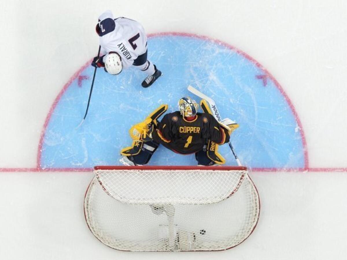 U.S. forward Sean Kuraly scores past Germany goalie Marvin Cupper during the first period.