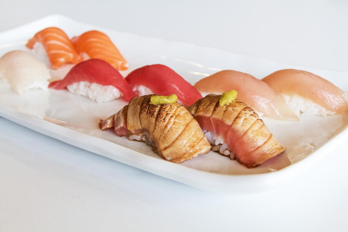 A white rectangular plate holds a nigiri sampler from Akafuji.