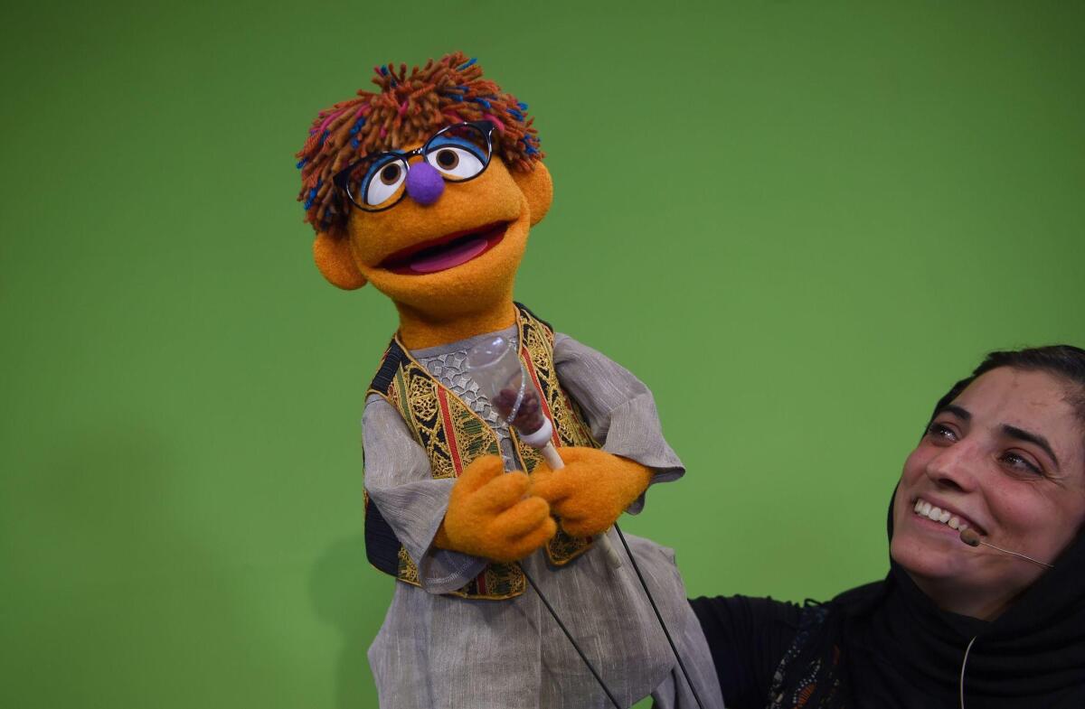 Puppeteer Seema Sultani holds Zeerak, the new muppet on Afghanistan's "Sesame Street" meant to promote education and gender equality.