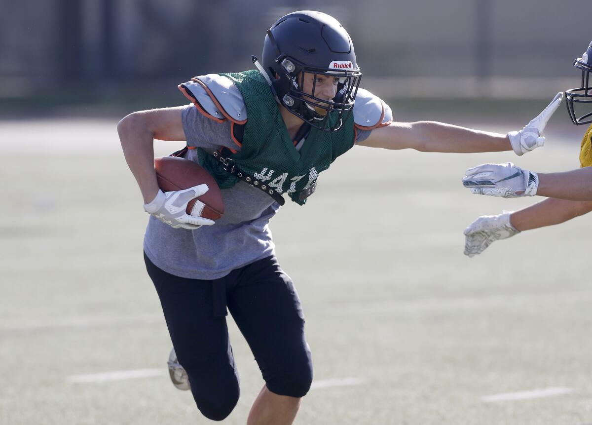 Sage Hill's Christopher Karahalios carries the ball during practice on Wednesday in Newport Beach.