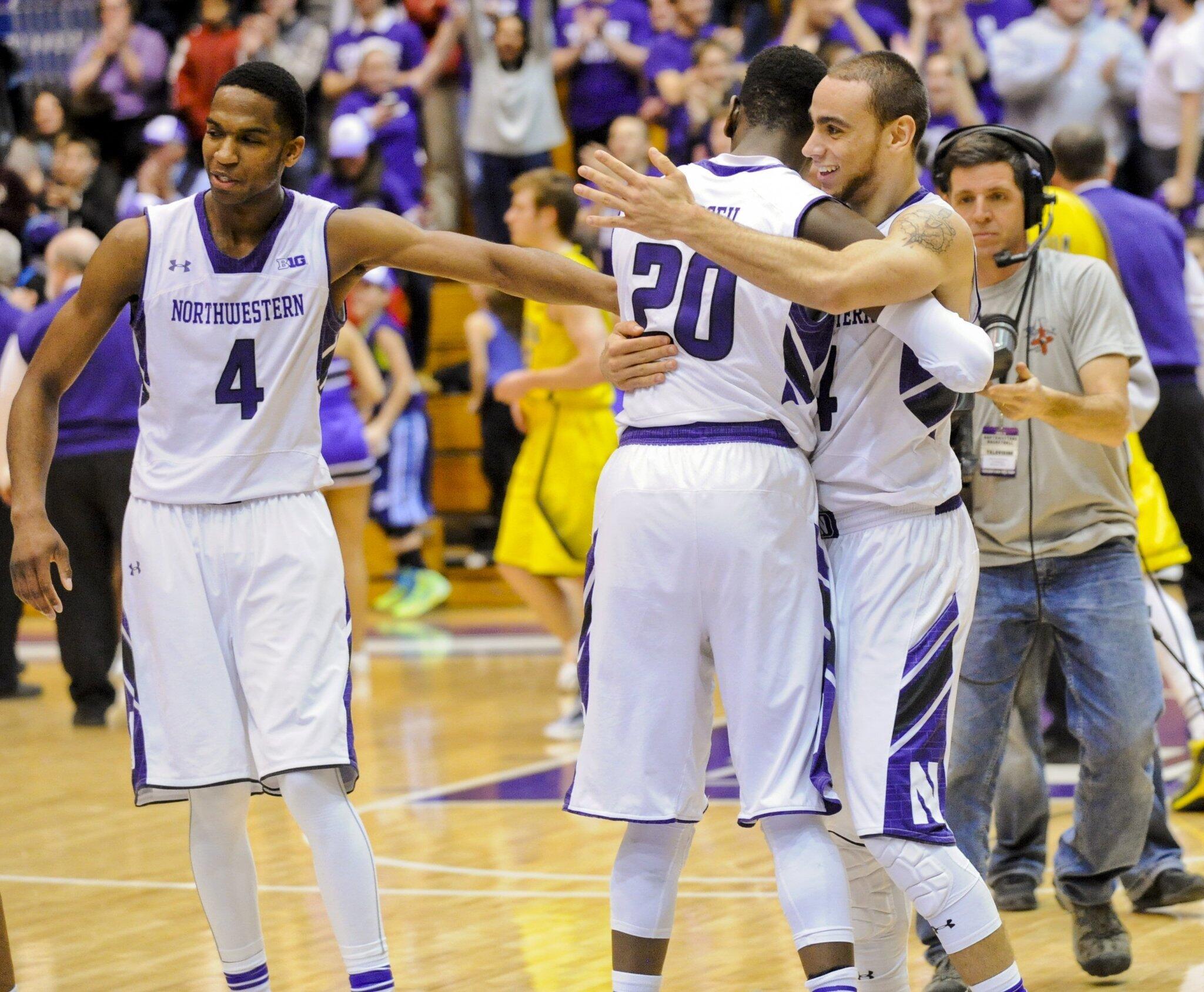 Northwestern's Tre Demps, right, Scottie Lindsey (20) and Vic Law celebrate at the end of the game.