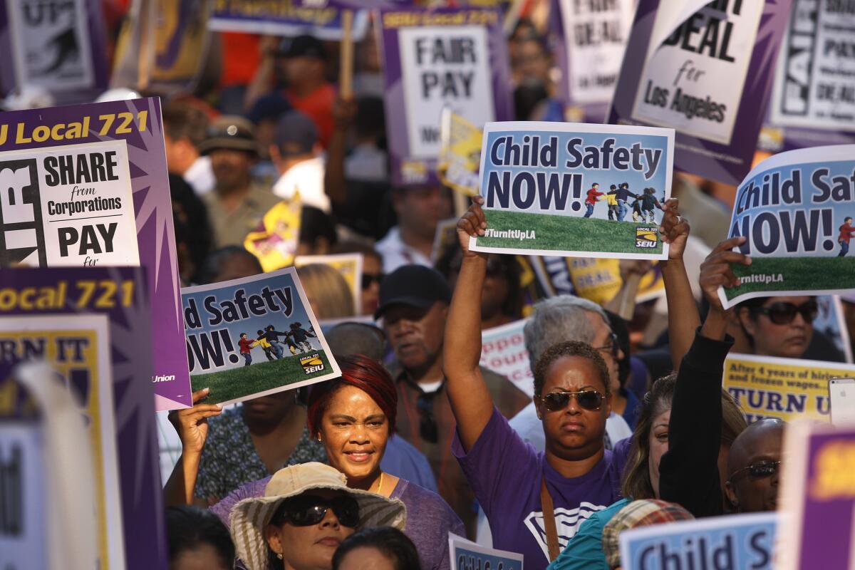 Thousands of Service Employees International Union members rally during a march at the California Plaza in downtown Los Angeles. The march ended at the Kenneth Hahn Hall of Administration.