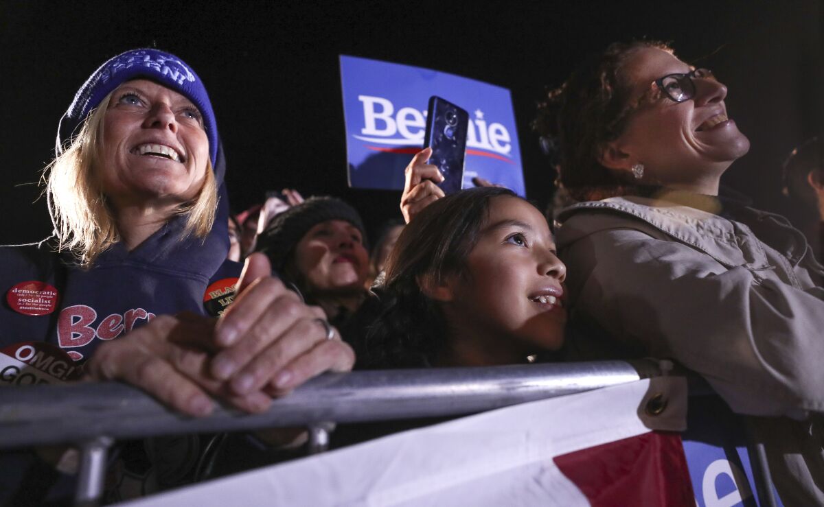 Supporters watch as Democratic presidential candidate Bernie Sanders speaks as he holds an immigration rally at San Ysidro High School on Friday, December 20, 2019 in San Diego, California.