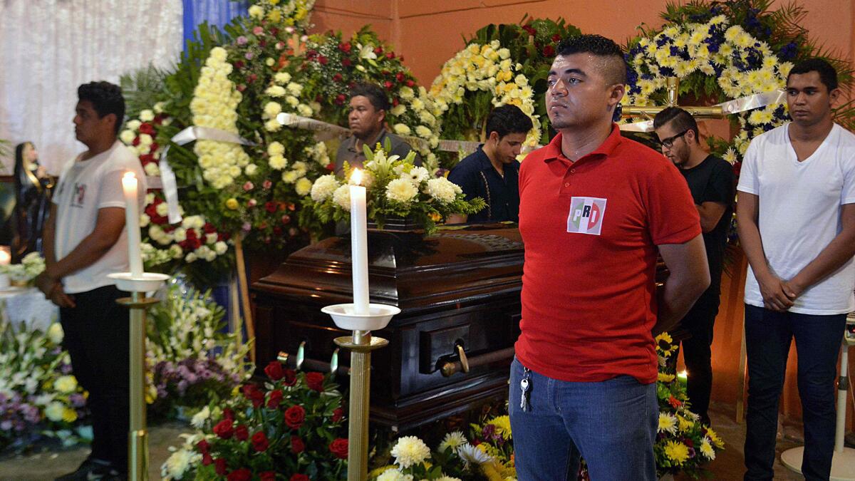 People attend services in Guerrero state's Las Vigas village for Rodrigo Salado Lorenzo, a candidate for alderman in the municipality of San Marcos, Mexico, on June 1, 2018.