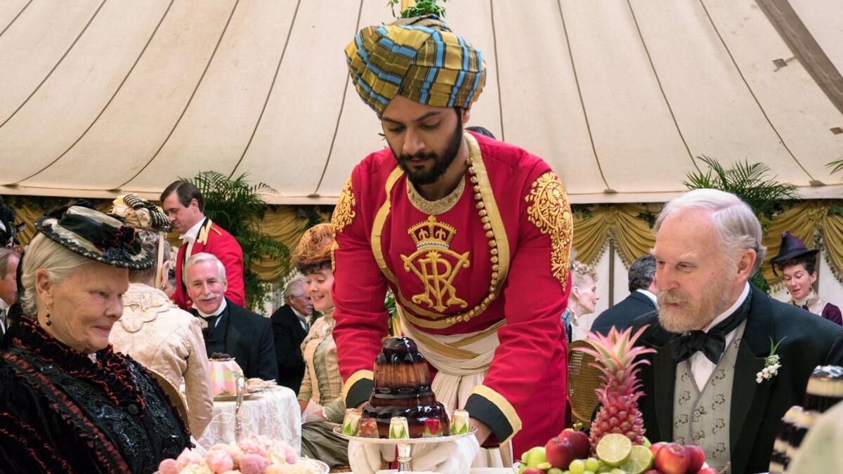 Ali Fazal, center, portrays a servant from India who is befriended by Judi Dench's Queen Victoria. With Tim Pigott-Smith. (Peter Mountain / Focus Features)