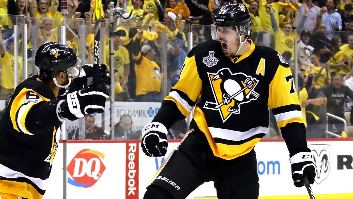 Penguins center Evgeni Malkin celebrates with teammate Trevor Daley after scoring against the Predators in Game 1 of the Stanley Cup Final on Monday night in Pittsburgh.