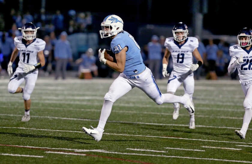 Corona del Mar's Mark Redman (81) sprints for a first half touchdown against Newport Harbor in the Battle of the Bay rivalry football game last season.