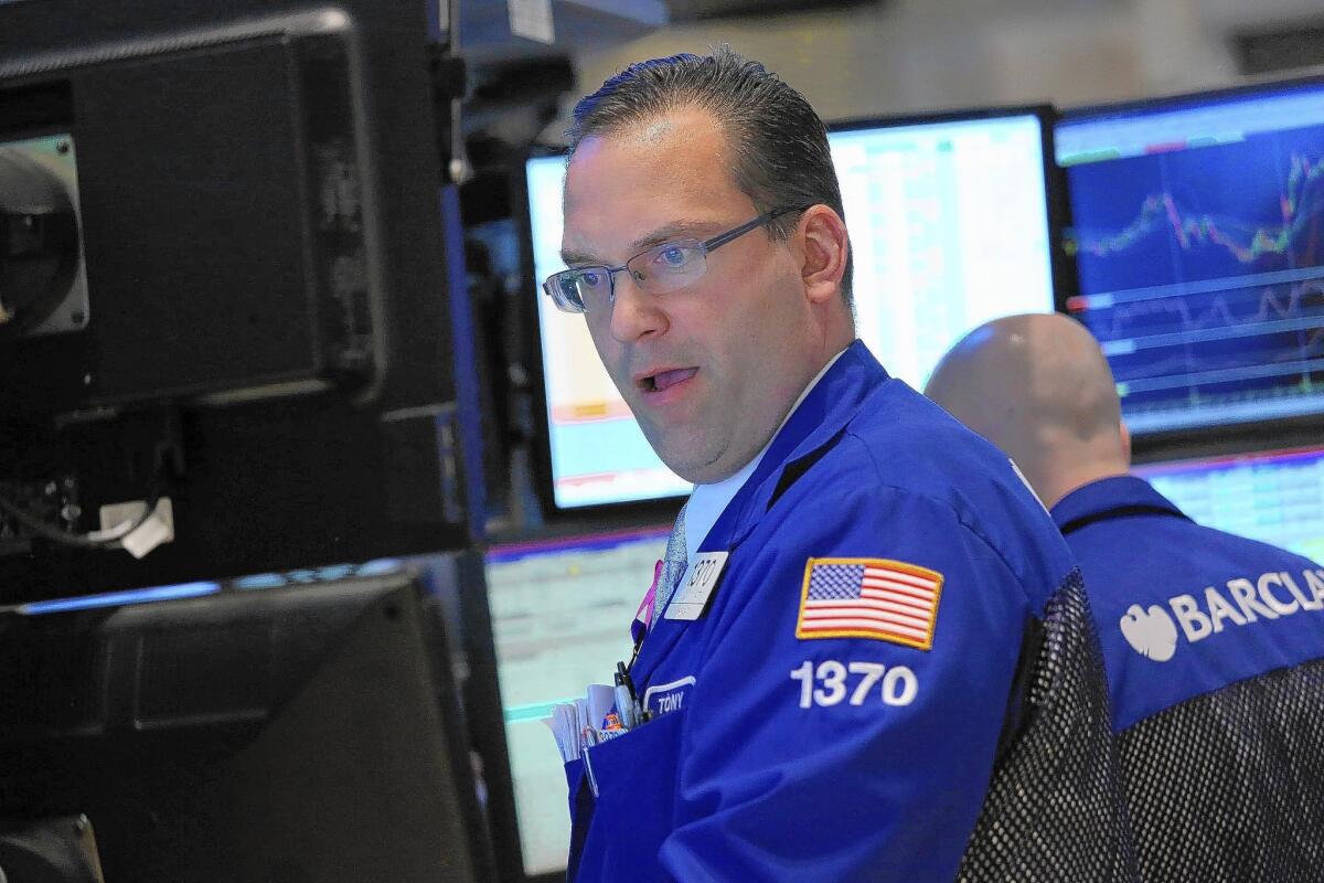 Traders work the floor of the New York Stock Exchange on Thursday. The stock sell-off was less a result of economic developments as it was the hard reality of a momentum-driven market.