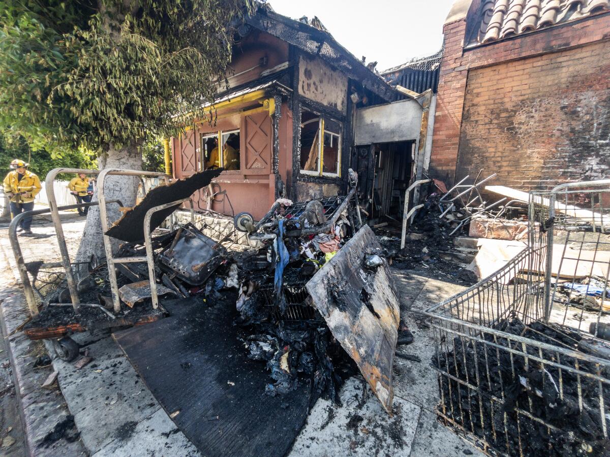 Soot, ash and debris outside a burned building.