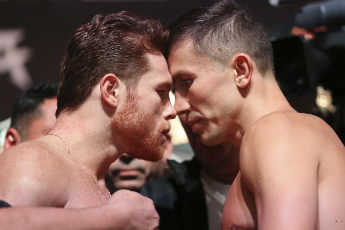 Canelo Alvarez, center left, and Gennady Golovkin pose during a weigh-in at T-Mobile Arena in Las Vegas, Friday, Sept. 14, 2018. Alvarez and Golovkin will fight Saturday night in a middleweight title bout. (Erik Verduzco/Las Vegas Review-Journal via AP)